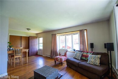 Large living room/dining room with hardwood floors
