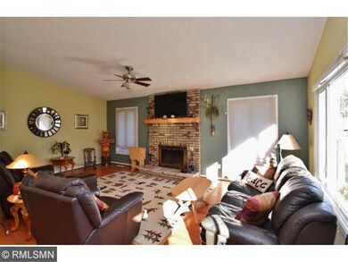 vaulted ceiling and wood fireplace in living room