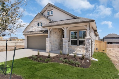 View of front of home with stucco siding, a garag