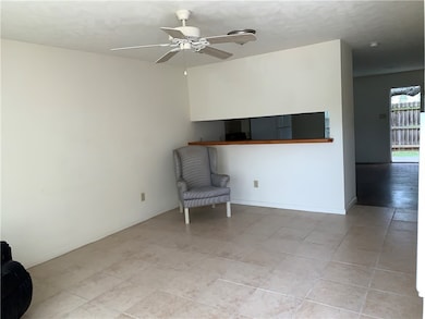 Unfurnished room with a ceiling fan and light tile