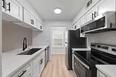 This modern kitchen features sleek white cabinetry