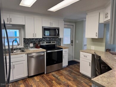 Kitchen with dishwasher, stove, ornamental molding
