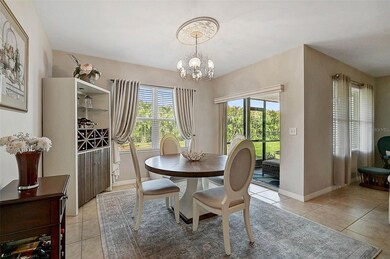 The well-lit dining area is bathed in natural light from the backyard window, highlighted by a beautiful handcrafted wooden valance, adding warmth and charm.