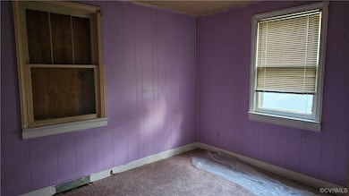 Carpeted spare room with baseboards