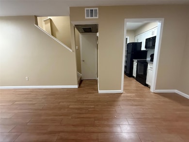 Unfurnished living room with light wood-type flooring and stairway