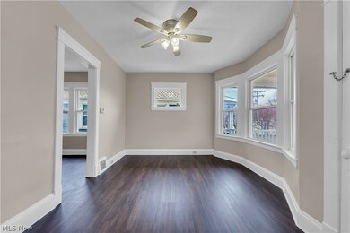 Spare room featuring ceiling fan and dark hardwood / wood-style flooring
