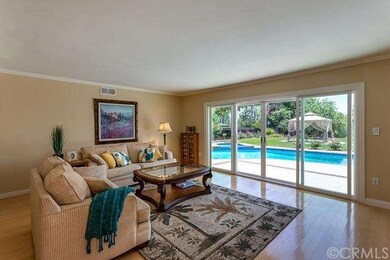 The formal living room has access to the backyard 