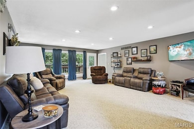 Living area with carpet floors and recessed lighting