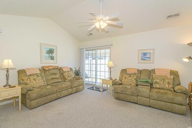 Living area featuring carpet floors, ceiling fan, 