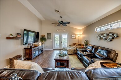 Living room with french doors, ceiling fan, vaulte