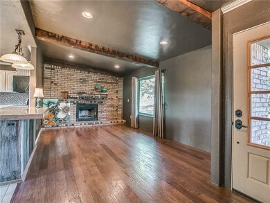 Beautiful hardwood floors and rustic beams give a 