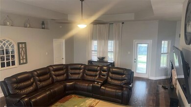 Living area with dark wood finished floors and bas