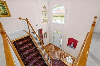 Carpeted foyer entrance featuring baseboards