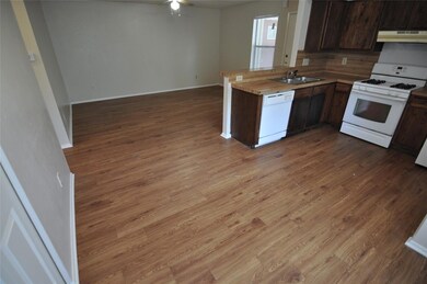 Kitchen featuring ceiling fan, white appliances, 