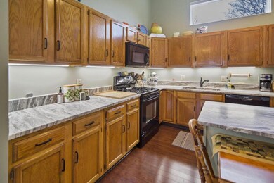 Closer view of kitchen - natural gas stove, granite counters, recently repainted
