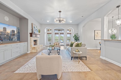 Living room with arched walkways, a chandelier, a