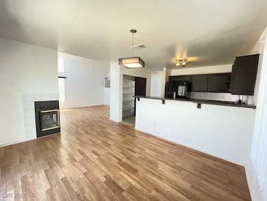 Unfurnished living room featuring a tiled fireplac