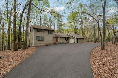 View of front of house with driveway and a garage