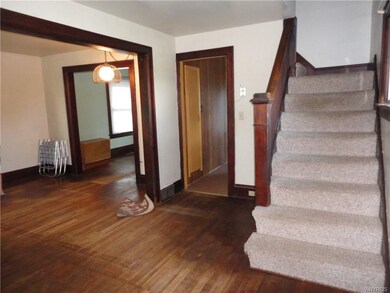 Spacious living room has hardwood floors. Open to 