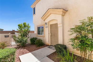 Home entrance with stucco siding and a security ga