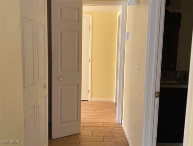 Hall with wood finish floors and baseboards