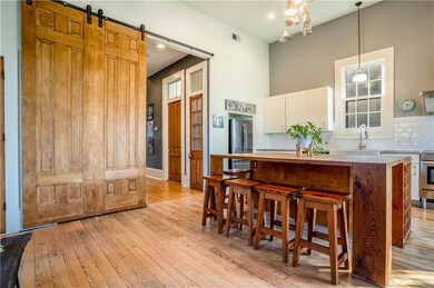 Grand cypress barn door separates the formal livin