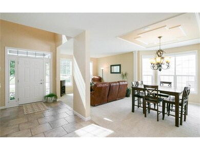 Formal Dining Room with Decorative Ceiling and Liv