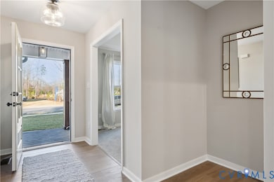Entrance foyer featuring wood finished floors and baseboards