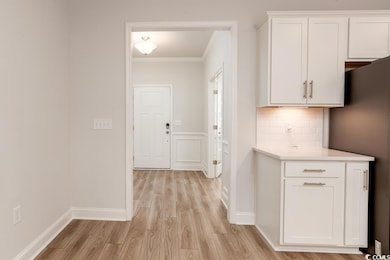 Hallway featuring light hardwood / wood-style floo