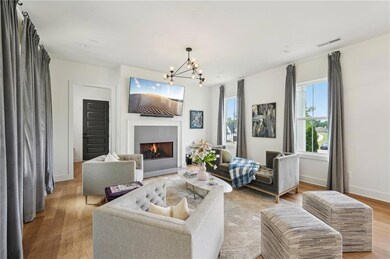 Living area with visible vents, baseboards, a warm