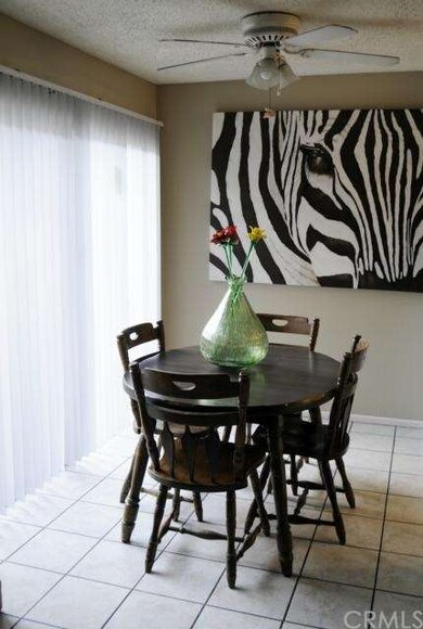 Dining area with overhead ceiling fan and patio en