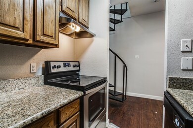 Kitchen featuring baseboards, dishwashing machine,