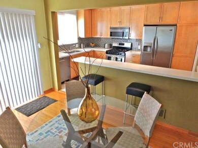 Open kitchen with eat-in bar. Maple cabinetry, qua