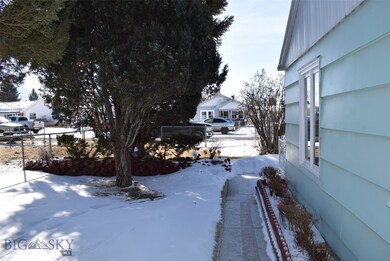 SIDE YARD WITH SHADE TREE AND SIDEWALK