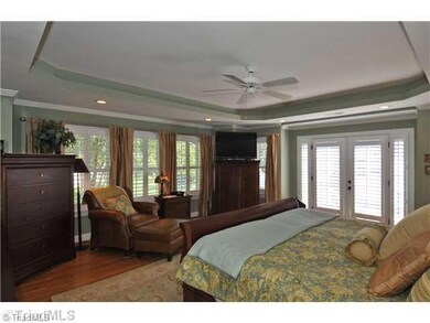 Master Bedroom. with trey ceiling, plantation shutters and access to courtyard