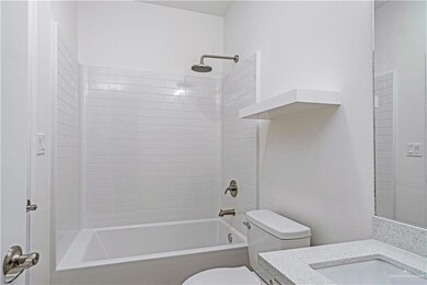 Full bathroom featuring vanity, toilet, and tiled shower / bath combo