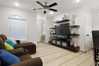 Living area with recessed lighting, baseboards, a ceiling fan, and wood finished floors