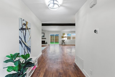 Corridor with wood finished floors and baseboards