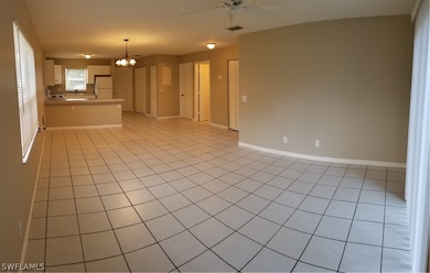 LIVING ROOM LOOKING AT KITCHEN (LEFT) MAIN ENTRANCE DOOR (CENTER) BEDROOM (RIGHT)