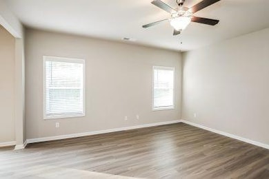 Empty room with baseboards, wood finished floors, 