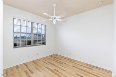 Spare room featuring wood finished floors and a ceiling fan