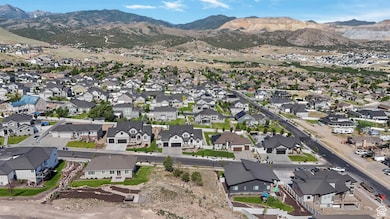 Aerial view of property's location with a mountainous background and nearby suburban area