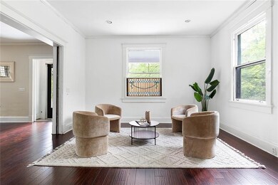 Living area featuring plenty of natural light, wood-type flooring, ornamental molding, and recessed lighting
