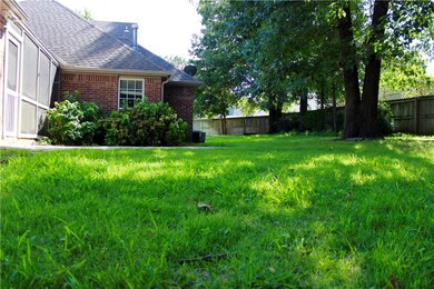 Back patio with screened in sunroom.