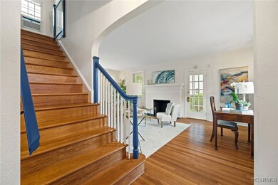 Stairs with wood finished floors, a brick fireplac