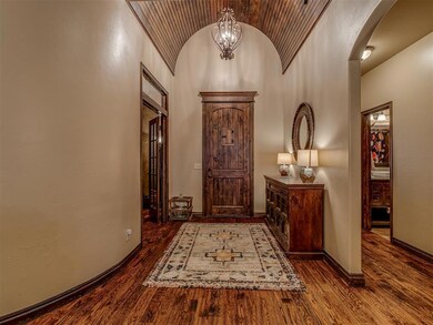 Entrance foyer featuring a chandelier, high vaulte