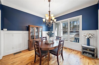 wainscoted wall and a notable chandelier