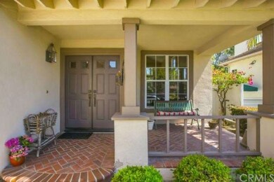 The covered brick porch is impressive as you walk 