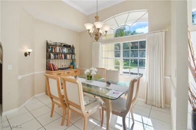 Dining room featuring ornamental molding, light ti
