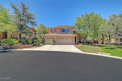 View of front of home featuring a front lawn, stucco siding, concrete driveway, and a garage